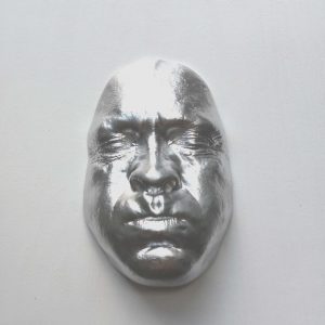 Silver effect Breathe on white background, wooden base 30x30cms