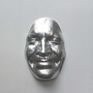 Silver effect Smile on white background, wooden base 30x30cms