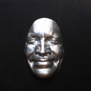 Silver effect Smile on black background, wooden base 30x30cms