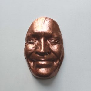 Copper effect Smile on white background, wooden base 30x30cms  250 Euros